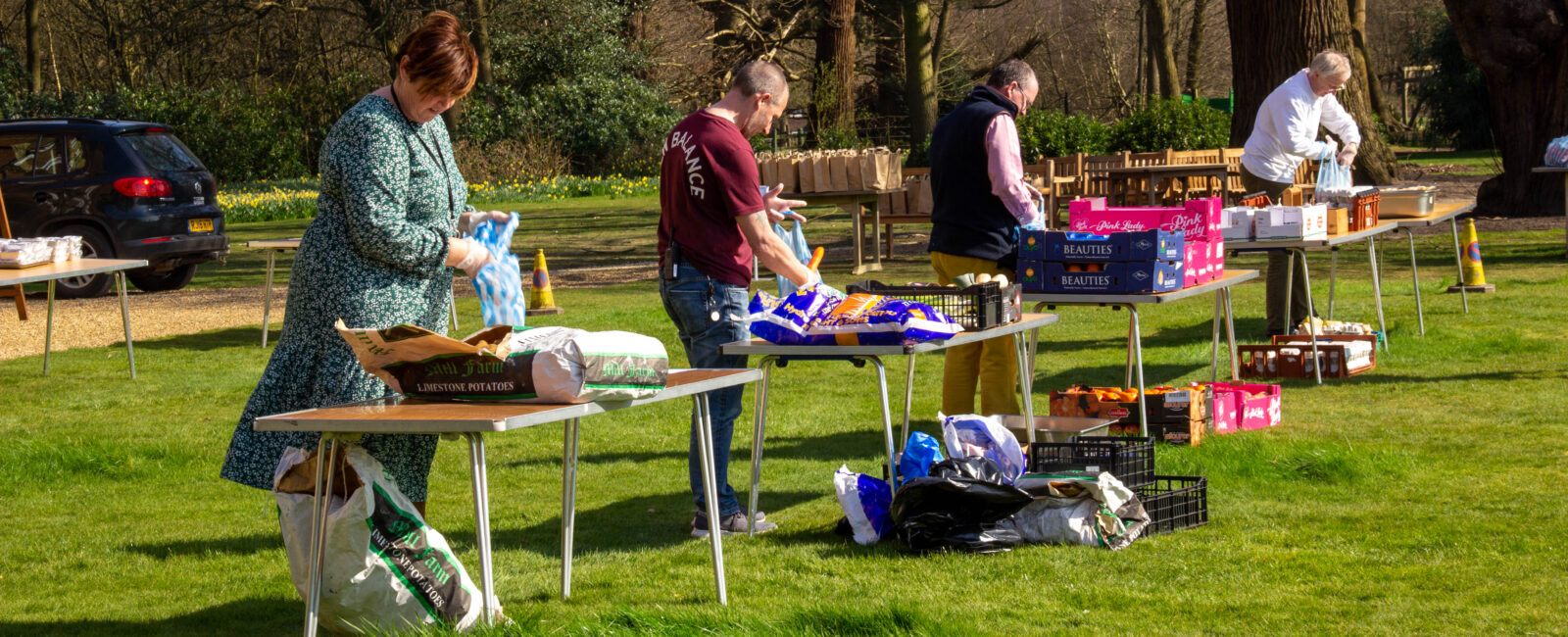 Senior managers at Cumberland Lodge, packing food parcels for the elderly in Windsor Great Park, during UK coronavirus pandemic