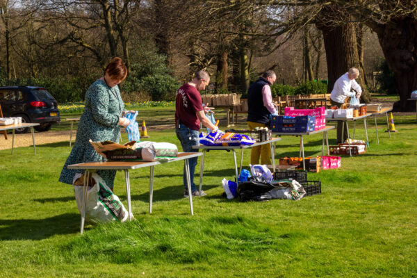 Senior managers at Cumberland Lodge, packing food parcels for the elderly in Windsor Great Park, during UK coronavirus pandemic