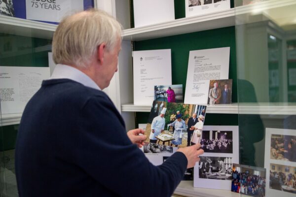 Chief Executive Dr Ed Newell adds a photo of the Queen to the exhibition cabinet