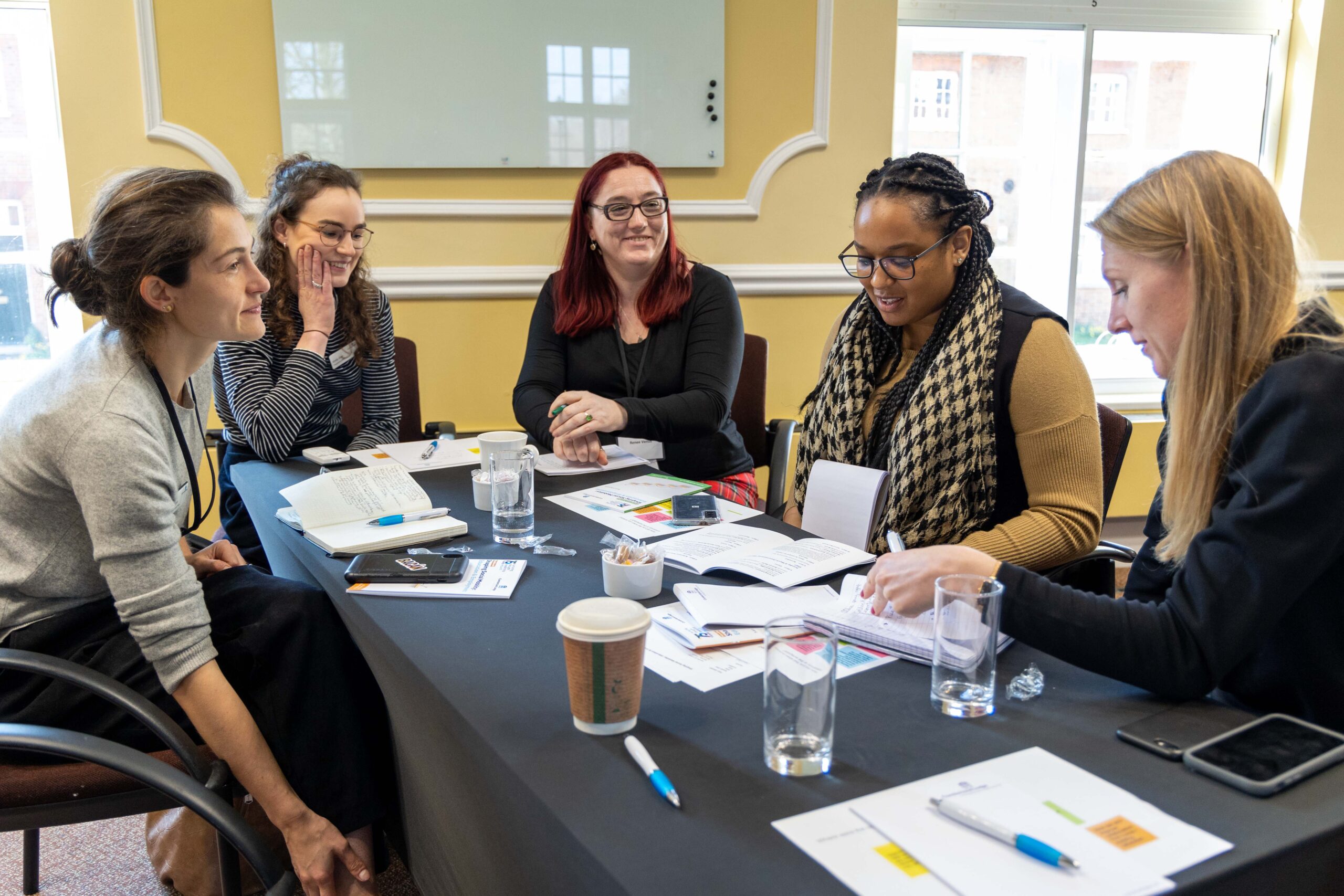 Students gathered around a table at an acedemic writing retreat