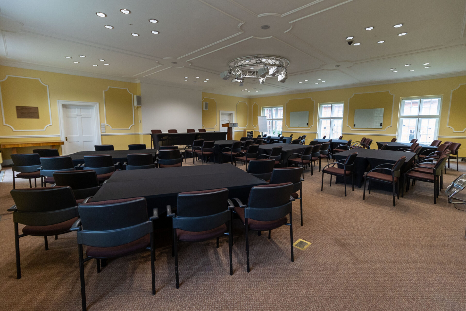 The Flitcroft conference room, set up to accommodate up to 60 people, sat at square tables.
