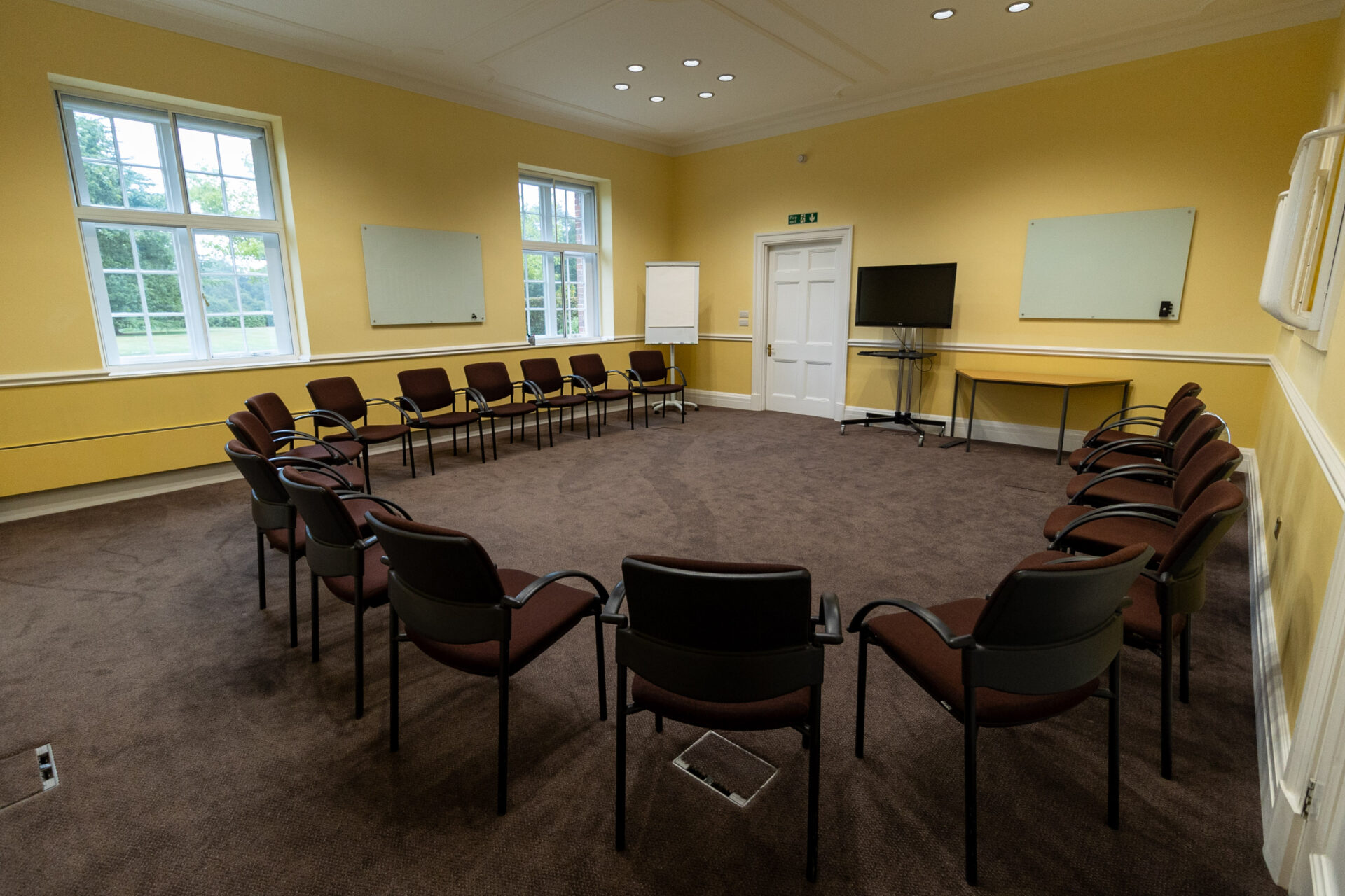 The Greening conference room, laid out in a U-shape to accommodate up to 16 people.