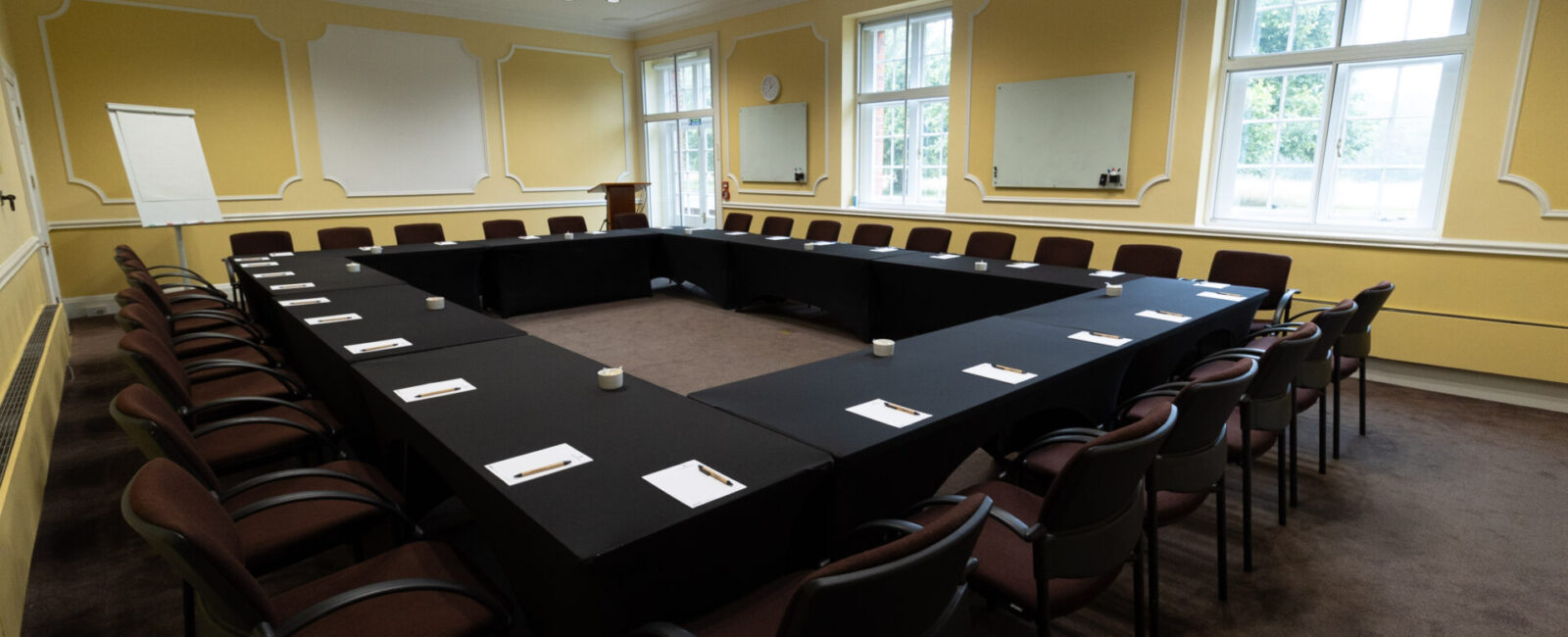 The Sandby conference room, set up in a boardroom layout to accommodate up to 30 people.
