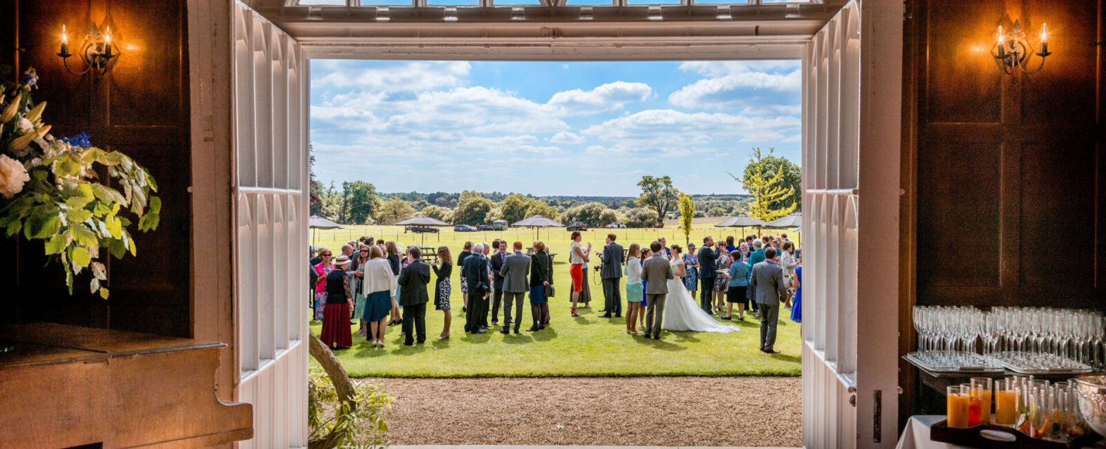 A wedding celebration taking place in the Cumberland Lodge gardens