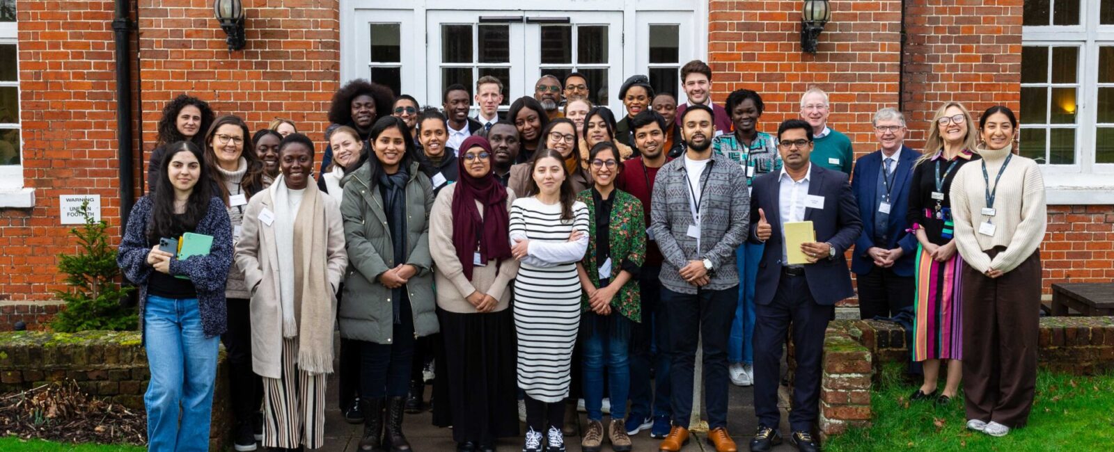 The first cohort of the Strengthening Rule of Law programme, outside The Mews building at their first retreat