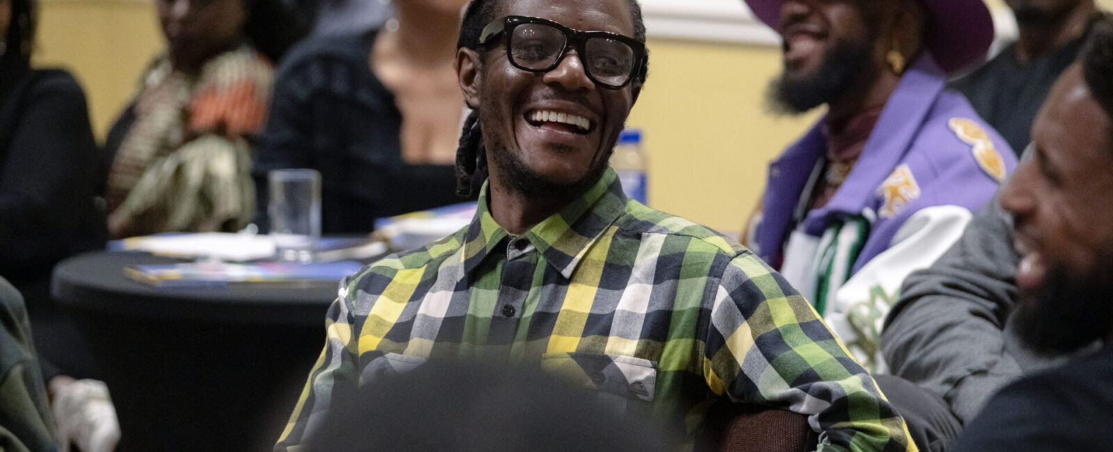 A delegate smiles during one of the Protecting Young Black Lives, Celebrating Black Professionals conference sessions