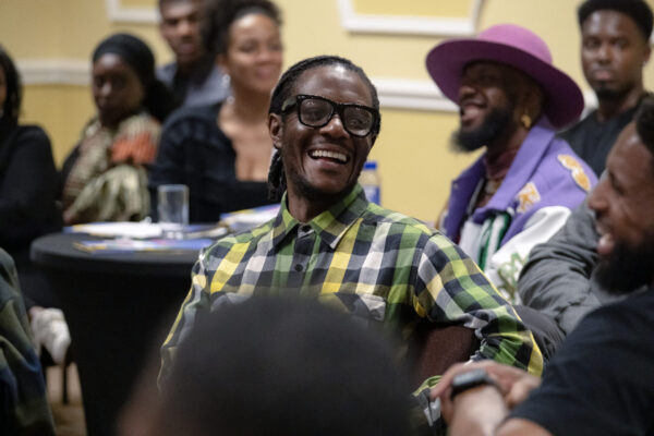 A delegate smiles during one of the Protecting Young Black Lives, Celebrating Black Professionals conference sessions