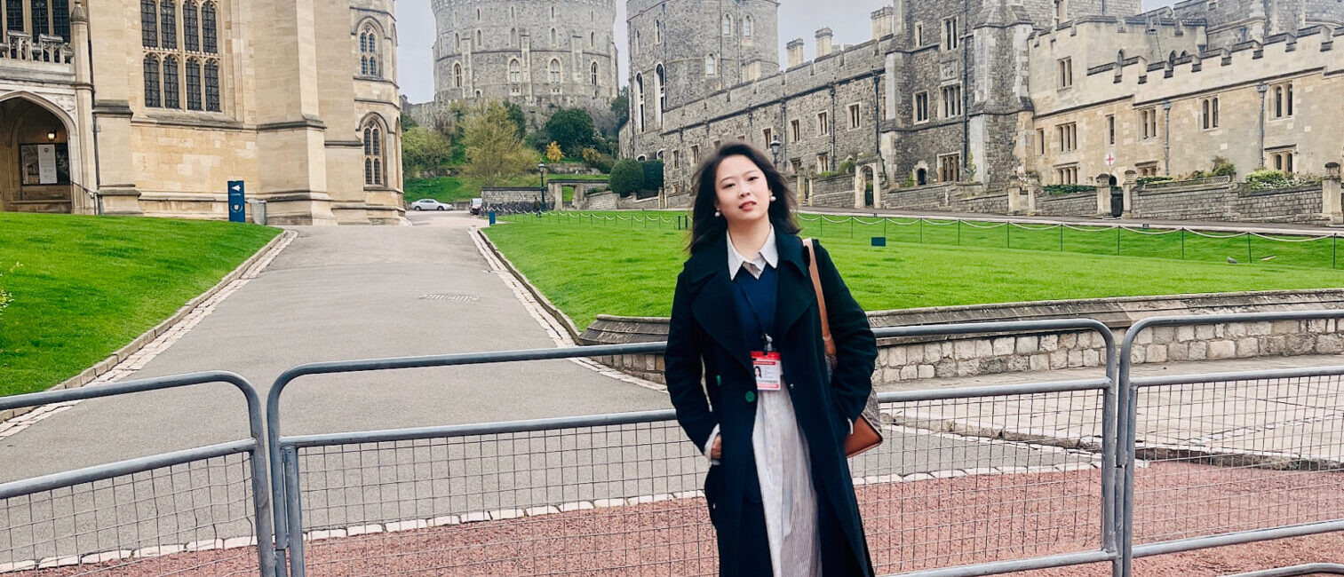 Cumberland Lodge Fellow Rong Wei stands outside St George's Chapel in the grounds of Windsor Castle