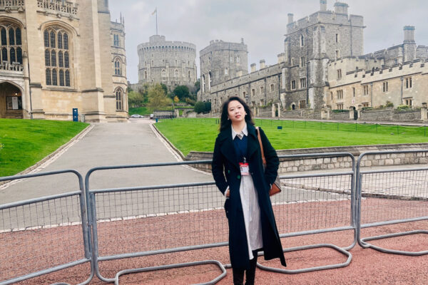 Cumberland Lodge Fellow Rong Wei stands outside St George's Chapel in the grounds of Windsor Castle