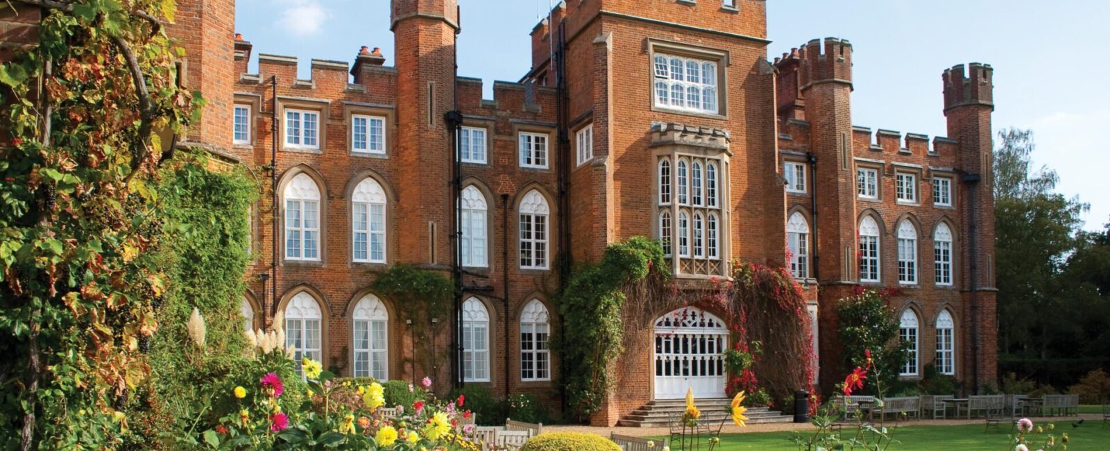 A view of Cumberland Lodge through a colourful flowerbed