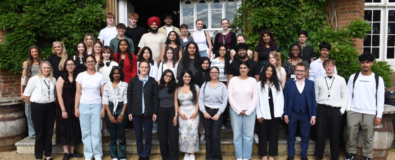 Students stand for a group photo outside Cumberland Lodge at the Magna Carta event.